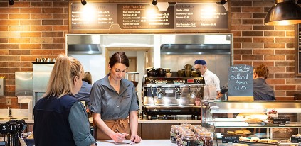 woman serving at cafe counter