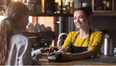 woman making contactless card payment