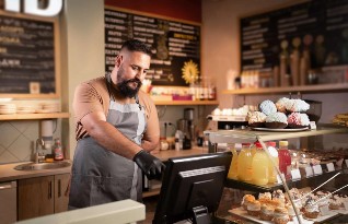 man using epos till in a cafe