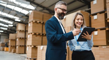 man and woman signing documents