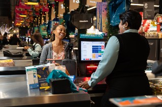 woman being served at till counter
