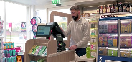 man using epos system in shop